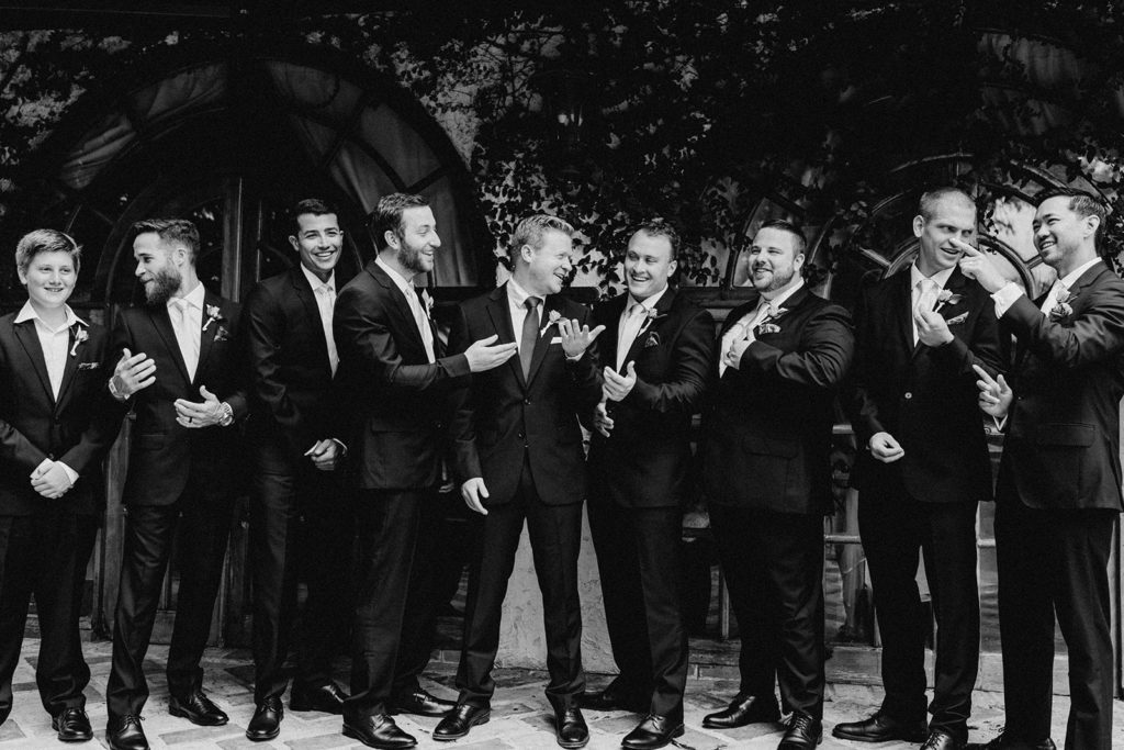groom and groomsman laughing for picture