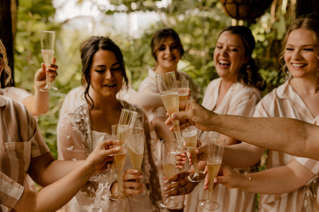 bride and bridesmaids cheers champaign at Hacienda Siesta Alegre venue